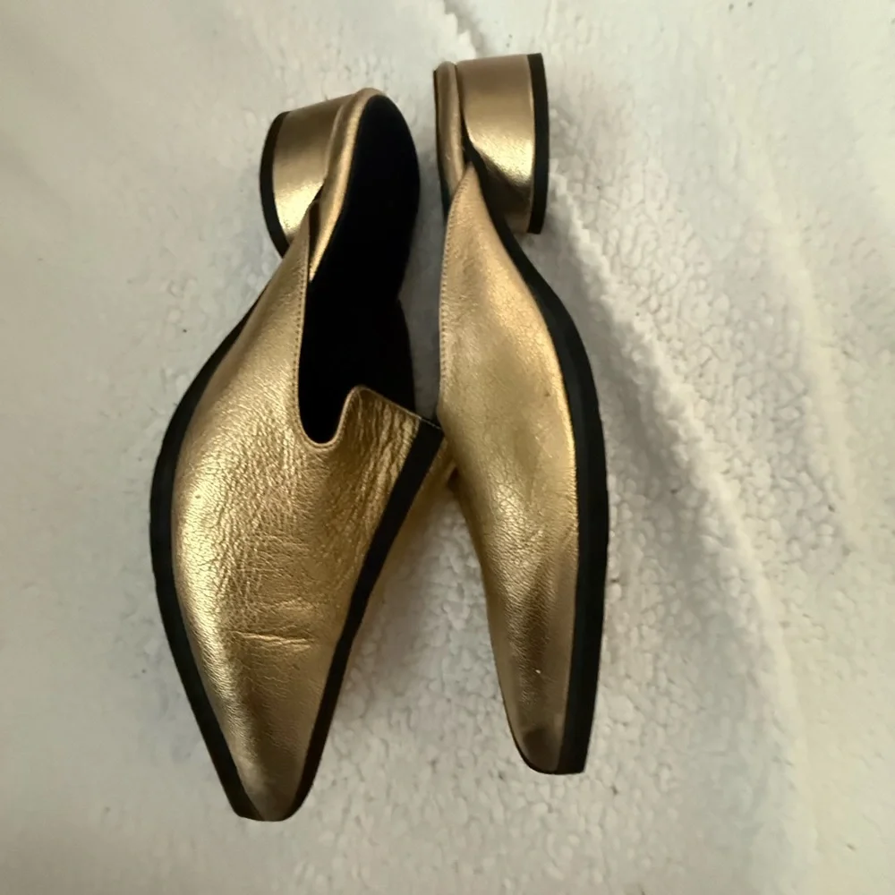 Andre Assoues gold and black slip on pointy style